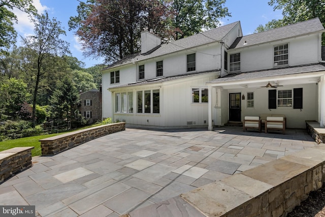 661 Timber Ln, Devon, PA 19333 - back of house with a ceiling fan, a patio, a chimney, roof with shingles, and stucco siding