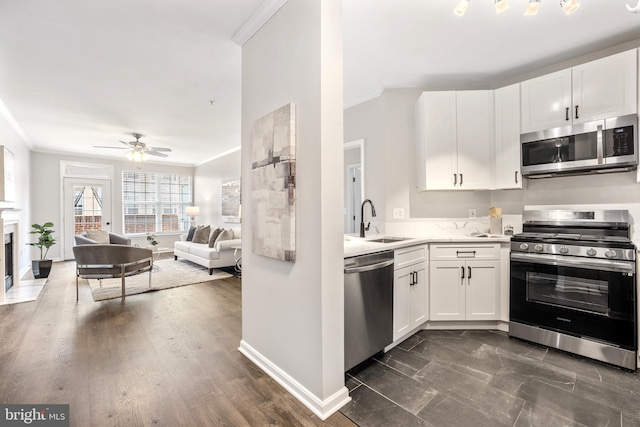 2701 Bellforest Ct Unit 305, Vienna, VA 22180 - kitchen featuring stainless steel appliances, a sink, ornamental molding, white cabinetry, and open floor plan