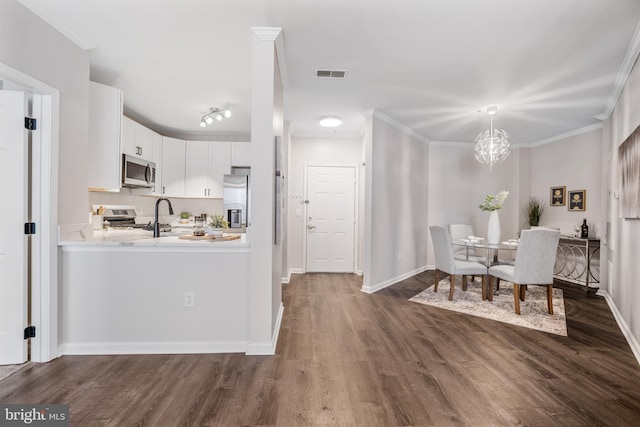 2701 Bellforest Ct Unit 305, Vienna, VA 22180 - dining room with dark wood-style flooring, crown molding, a chandelier, and baseboards