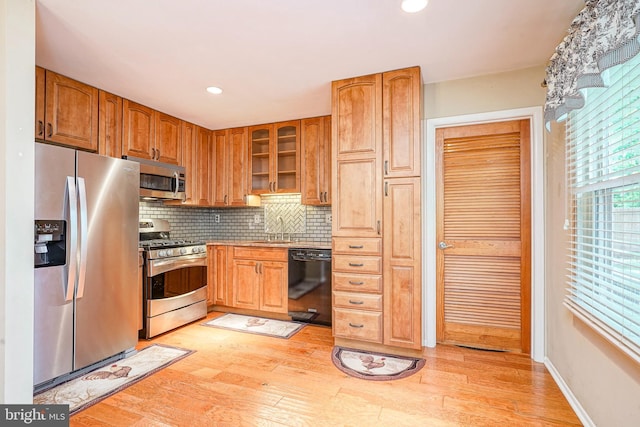 1035 S Beecham Rd, Williamstown, NJ 08094 - kitchen with appliances with stainless steel finishes, a sink, tasteful backsplash, light wood-style flooring, and glass insert cabinets