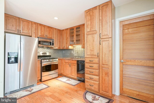 1035 S Beecham Rd, Williamstown, NJ 08094 - kitchen featuring appliances with stainless steel finishes, a sink, light wood-style floors, decorative backsplash, and glass insert cabinets