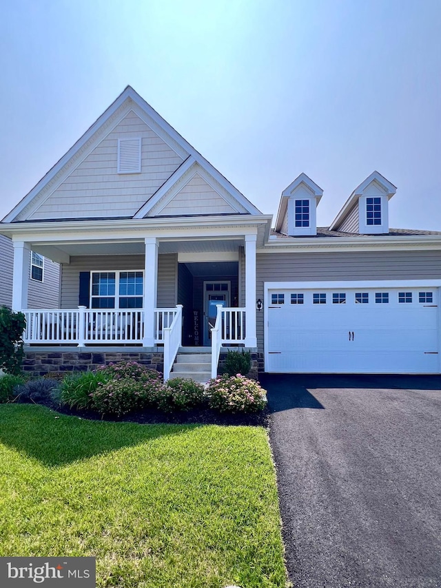 1143 Kayla Ln, Townsend, DE 19734 - view of front facade with a front yard, driveway, a porch, and a garage