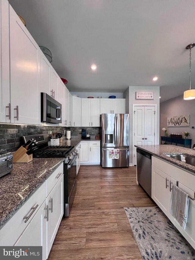 1143 Kayla Ln, Townsend, DE 19734 - kitchen featuring appliances with stainless steel finishes, white cabinetry, dark stone counters, and recessed lighting