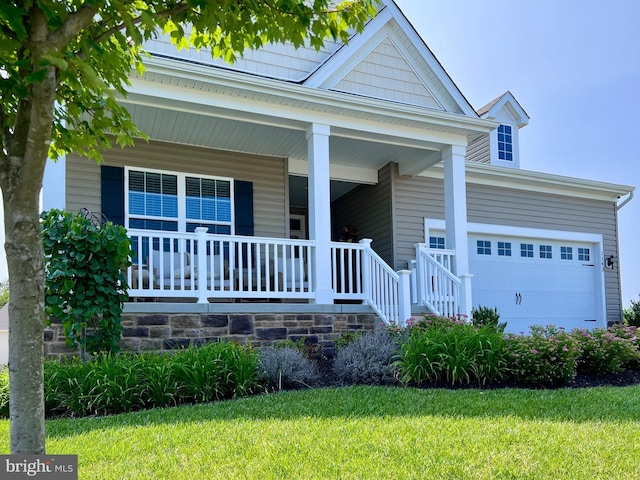 1143 Kayla Ln, Townsend, DE 19734 - view of front of home featuring a garage, covered porch, and a front lawn