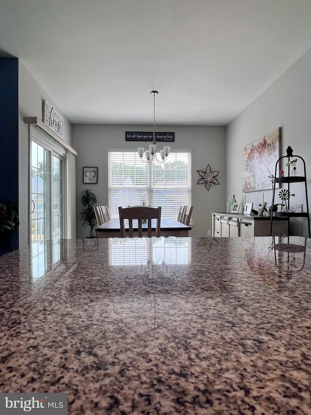 1143 Kayla Ln, Townsend, DE 19734 - kitchen with a chandelier, a desk, stone countertops, and decorative light fixtures