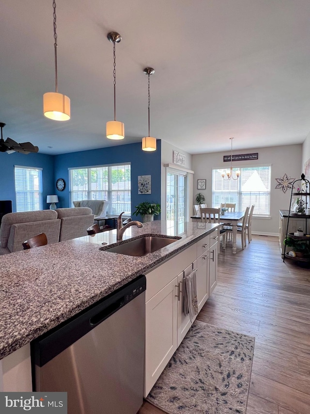 1143 Kayla Ln, Townsend, DE 19734 - kitchen with dishwasher, a sink, white cabinets, and healthy amount of natural light