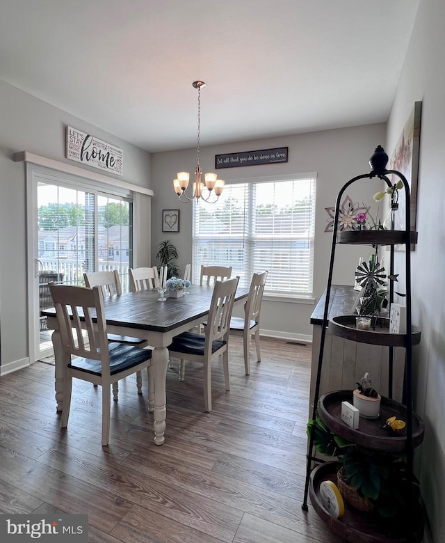 1143 Kayla Ln, Townsend, DE 19734 - dining room with a chandelier, wood finished floors, and baseboards
