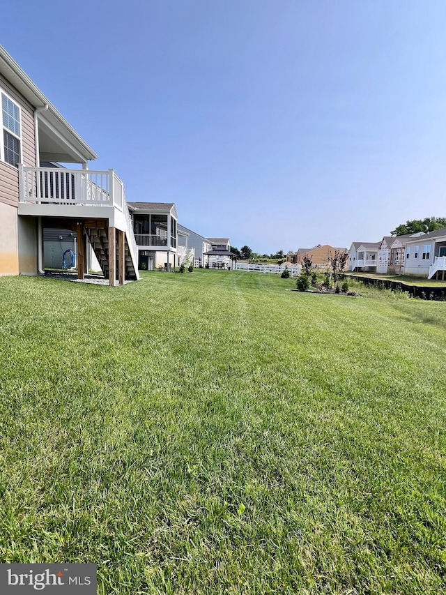1143 Kayla Ln, Townsend, DE 19734 - view of green lawn with stairway and a deck