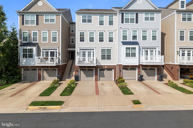 45711 Winding Branch Ter, Sterling, VA 20166 - townhome / multi-family property featuring brick siding, driveway, and an attached garage
