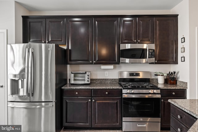 45711 Winding Branch Ter, Sterling, VA 20166 - kitchen featuring stainless steel appliances, dark stone counters, and dark brown cabinetry