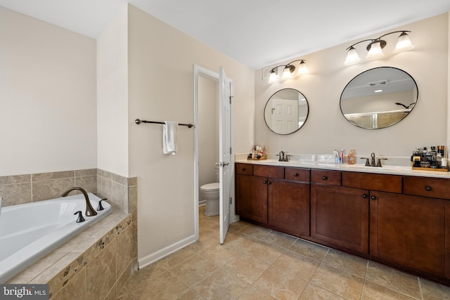 45711 Winding Branch Ter, Sterling, VA 20166 - full bath featuring double vanity, a garden tub, toilet, baseboards, and tile patterned floors