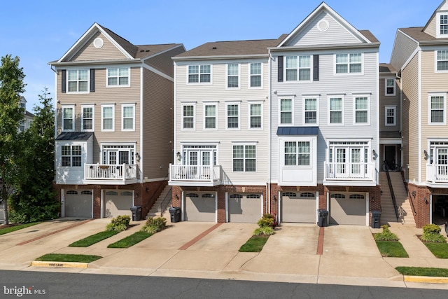 45711 Winding Branch Ter, Sterling, VA 20166 - view of property featuring stairs, driveway, brick siding, and a garage