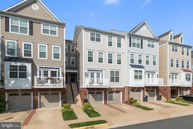 45711 Winding Branch Ter, Sterling, VA 20166 - view of property featuring driveway, an attached garage, and brick siding
