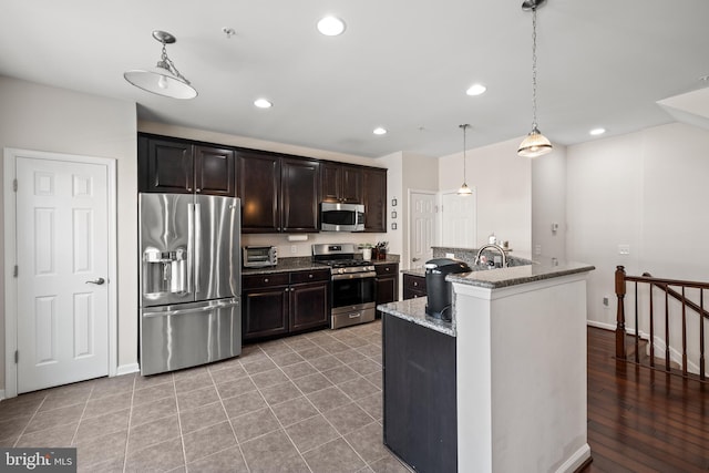 45711 Winding Branch Ter, Sterling, VA 20166 - kitchen featuring appliances with stainless steel finishes, stone counters, pendant lighting, recessed lighting, and dark brown cabinets