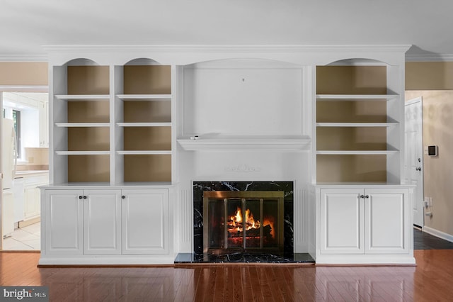 516 Merrimans Ln, Winchester, VA 22601 - detailed view of wood finished floors, ornamental molding, a fireplace, built in features, and freestanding refrigerator