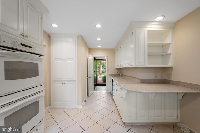 516 Merrimans Ln, Winchester, VA 22601 - kitchen with double oven, light countertops, white cabinetry, and recessed lighting