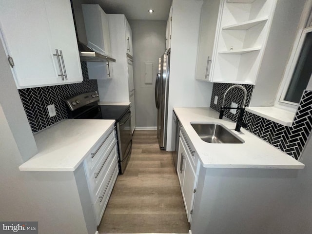 1742 U St NW Unit 203, Washington, DC 20009 - kitchen featuring stainless steel appliances, a sink, light wood-style floors, tasteful backsplash, and recessed lighting
