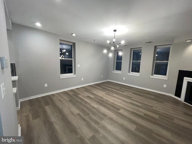 1742 U St NW Unit 203, Washington, DC 20009 - unfurnished living room with dark wood finished floors, baseboards, a chandelier, and recessed lighting