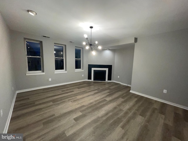 1742 U St NW Unit 203, Washington, DC 20009 - unfurnished living room with a chandelier, dark wood finished floors, baseboards, and a fireplace
