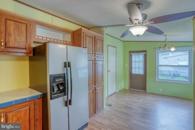 32588 Captains Way, Millsboro, DE 19966 - kitchen featuring stainless steel fridge with ice dispenser, brown cabinetry, a textured ceiling, and ceiling fan