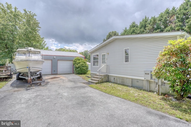 32588 Captains Way, Millsboro, DE 19966 - view of front of home with an outdoor structure, entry steps, and a garage