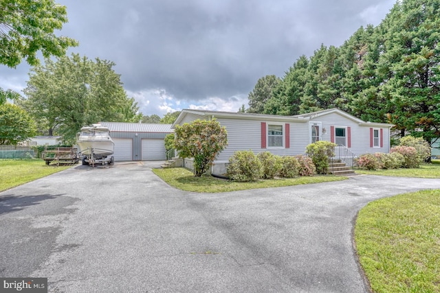 32588 Captains Way, Millsboro, DE 19966 - view of front of property featuring an outbuilding, a detached garage, and a front lawn