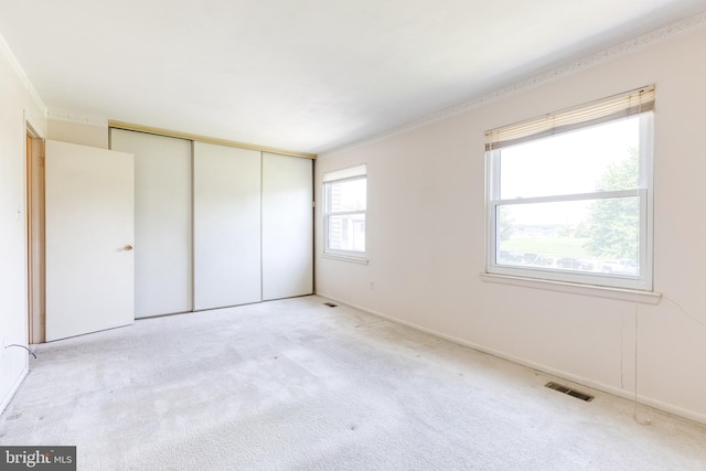 8798 Victory Ct, Walkersville, MD 21793 - unfurnished bedroom with light carpet, a closet, and crown molding