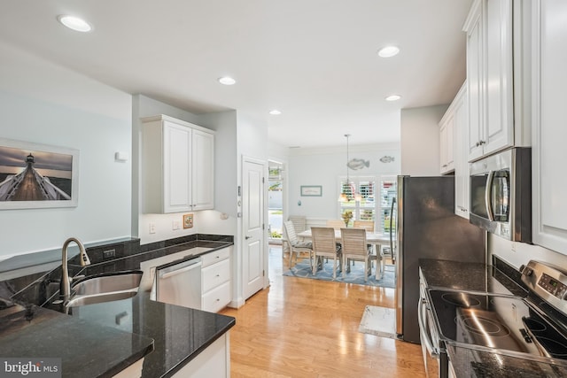 36769 E Pebble Beach Dr, Frankford, DE 19945 - kitchen with appliances with stainless steel finishes, white cabinets, light wood finished floors, dark stone counters, and recessed lighting
