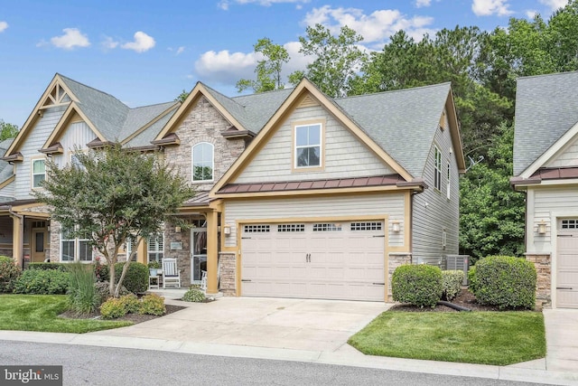 36769 E Pebble Beach Dr, Frankford, DE 19945 - craftsman-style home with stone siding, a standing seam roof, driveway, roof with shingles, and a metal roof