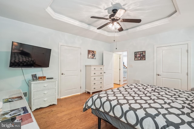 36769 E Pebble Beach Dr, Frankford, DE 19945 - bedroom featuring a raised ceiling, crown molding, light wood-style flooring, and ceiling fan