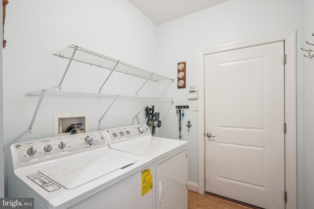 36769 E Pebble Beach Dr, Frankford, DE 19945 - laundry room with independent washer and dryer and light wood-type flooring