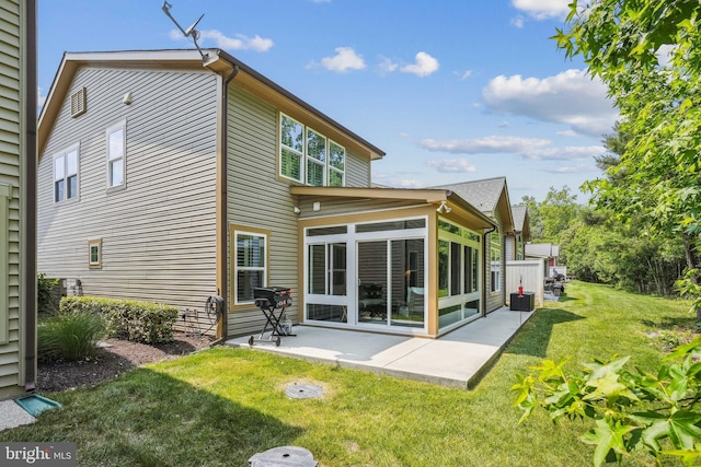 36769 E Pebble Beach Dr, Frankford, DE 19945 - rear view of house with a sunroom, a yard, and a patio
