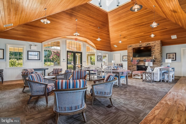 36769 E Pebble Beach Dr, Frankford, DE 19945 - carpeted living room featuring a wainscoted wall, wood ceiling, a fireplace, and high vaulted ceiling