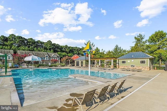 36769 E Pebble Beach Dr, Frankford, DE 19945 - community pool with a patio area and view of wooded area