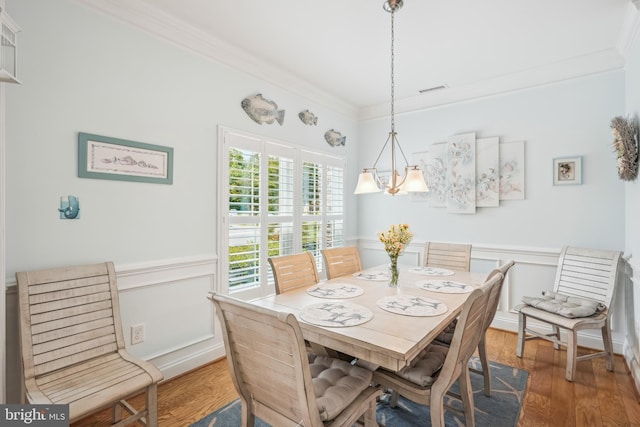 36769 E Pebble Beach Dr, Frankford, DE 19945 - dining room featuring ornamental molding, wood finished floors, wainscoting, and a decorative wall