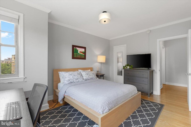 3028 Wisconsin Ave NW Unit 402, Washington, DC 20016 - bedroom with ornamental molding, light wood-type flooring, and a desk