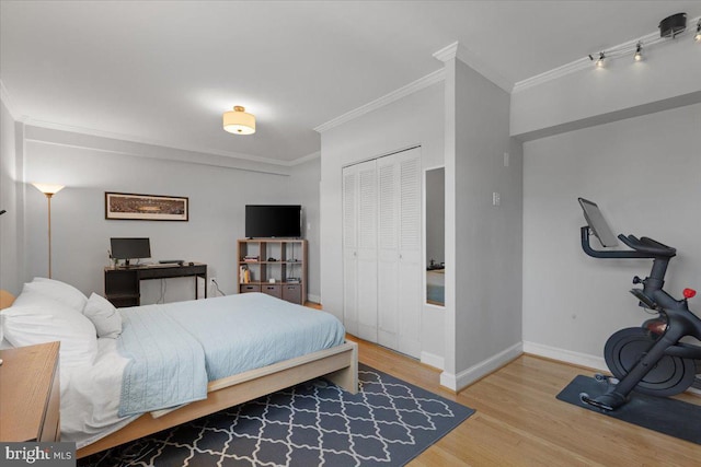 3028 Wisconsin Ave NW Unit 402, Washington, DC 20016 - bedroom with crown molding, wood finished floors, and a closet