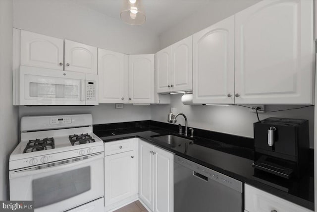3028 Wisconsin Ave NW Unit 402, Washington, DC 20016 - kitchen with white appliances, white cabinetry, and dark countertops