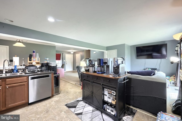 53 Skyview Cir, Hanover, PA 17331 - kitchen featuring stainless steel dishwasher, a sink, open floor plan, dark countertops, and brown cabinetry