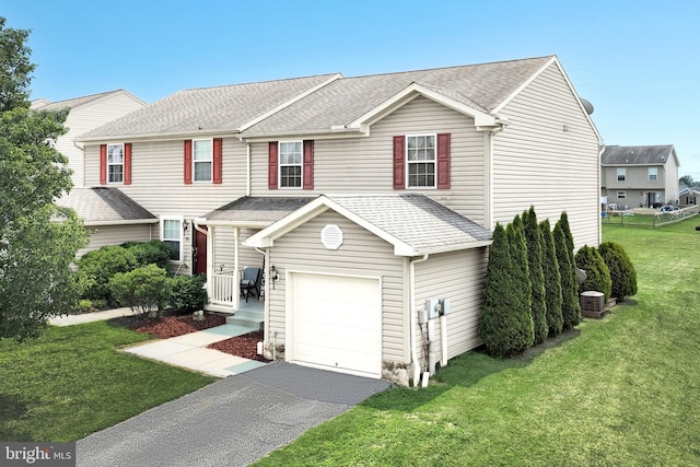 53 Skyview Cir, Hanover, PA 17331 - view of front facade with an attached garage, asphalt driveway, central air condition unit, a front lawn, and roof with shingles