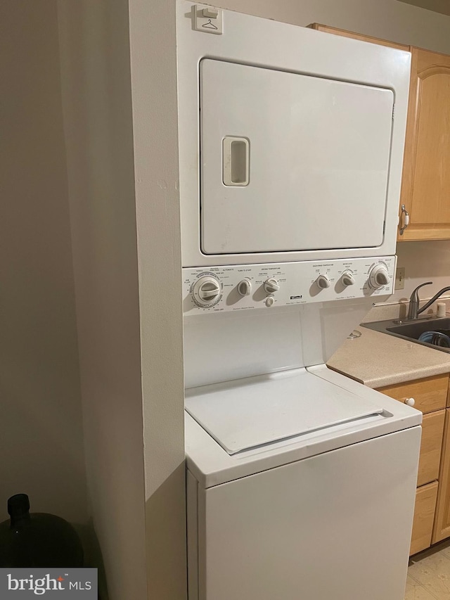 12001 Old Columbia Pike Unit 207, Silver Spring, MD 20904 - washroom with stacked washer / drying machine and cabinet space