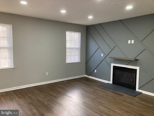 9831 Endora Ct, Owings Mills, MD 21117 - unfurnished living room featuring baseboards, a large fireplace, wood finished floors, and recessed lighting