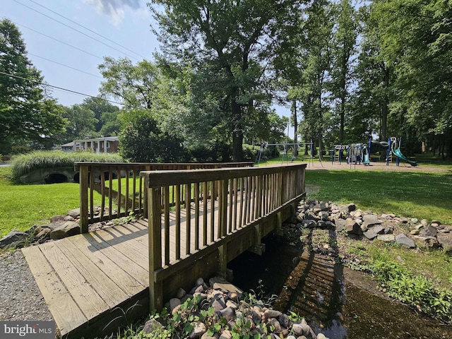 10702 Orchard St, Fairfax, VA 22030 - wooden terrace with a playground, a yard, and view of wooded area