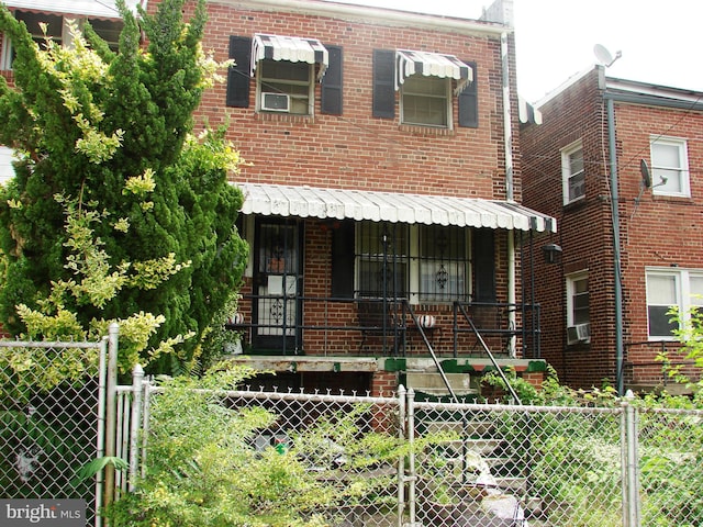 610 NE 21st St NE, Washington, DC 20002 - view of property with a porch, brick siding, and cooling unit