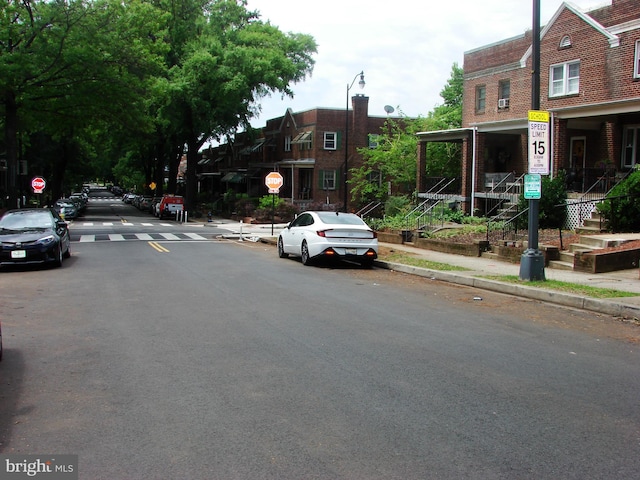 610 NE 21st St NE, Washington, DC 20002 - view of asphalt street featuring traffic signs, sidewalks, curbs, and street lights
