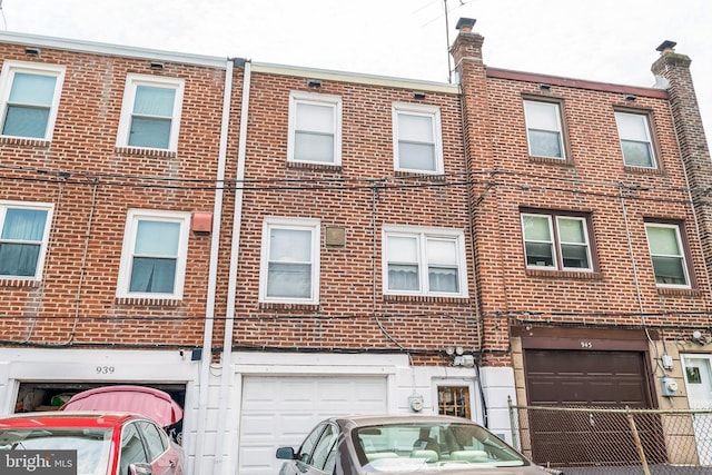 941 Fairfax Rd, Drexel Hill, PA 19026 - view of front facade with brick siding and an attached garage