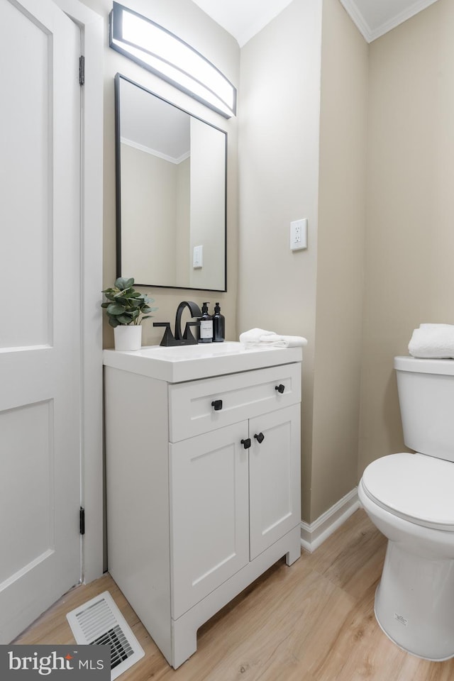 1224 W Mill St, Quakertown, PA 18951 - half bath featuring vanity, toilet, wood finished floors, crown molding, and baseboards