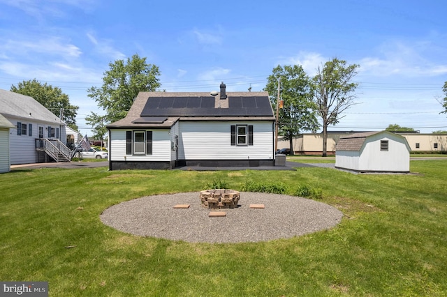 1224 W Mill St, Quakertown, PA 18951 - back of property with roof mounted solar panels, a lawn, roof with shingles, a fire pit, and a chimney