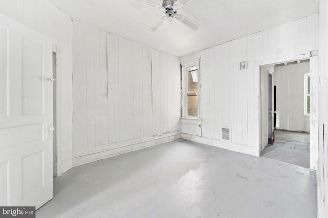 916 S 8th St, Camden, NJ 08102 - spare room featuring unfinished concrete flooring, ceiling fan, and wood walls
