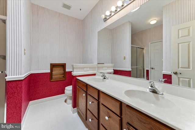 916 E Fox Hound Chase Chase, Glen Mills, PA 19342 - bathroom featuring wallpapered walls, a shower stall, toilet, double vanity, and baseboards